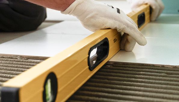 Tile flooring installation with level tool