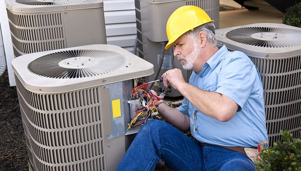 HVAC technician servicing a residential heat pump system