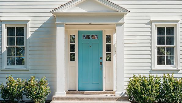 White house siding with turquoise front door