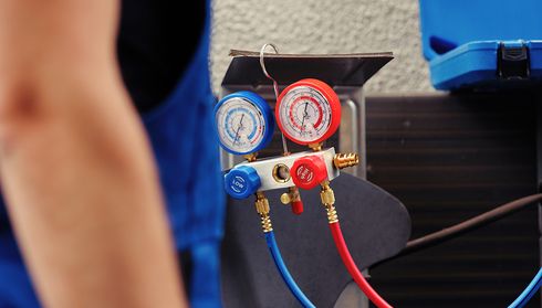 A technician is checking the air conditioning system