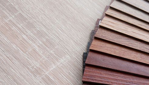 Close-up of laminate flooring samples showing wood tones