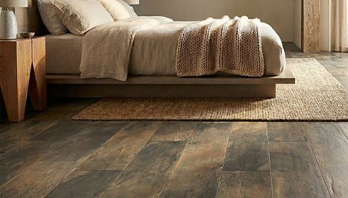 Bedroom with dark laminate flooring and woven rug
