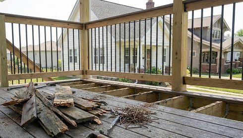 Damaged wooden deck with rotting boards
