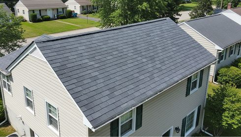 Worn asphalt shingle roof on a suburban home