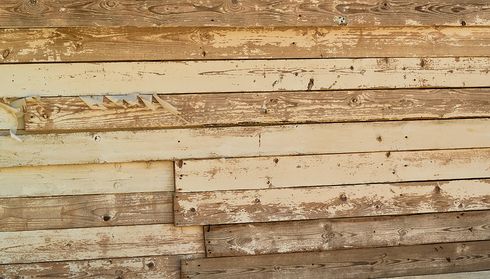 Weathered wood siding with peeling paint