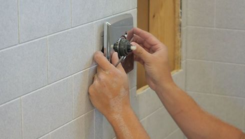 Installing a shower handle on a tiled bathroom wall