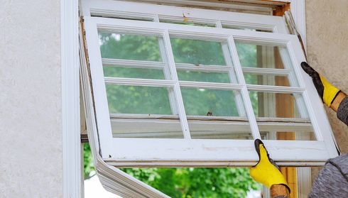 Removing an old white window frame from a wall