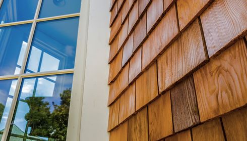 Close-up of a corner of a building with wooden shingles
