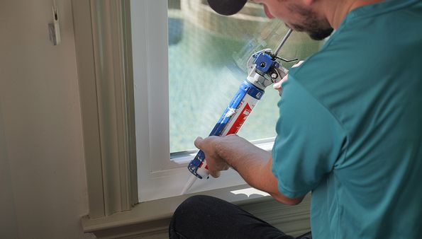 Vinyl window installation with sealant during replacement process